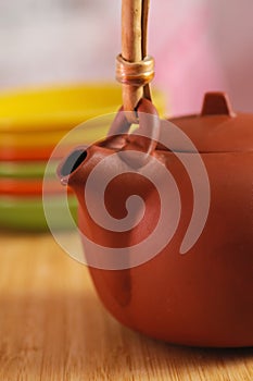 Clay teapot on color plates backgrounds