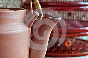 Clay teapot in front of bamboo basket