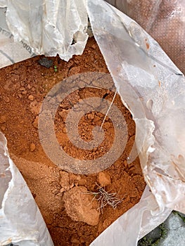 Clay for tennis court stored in a bag or sack ready to be spilled.