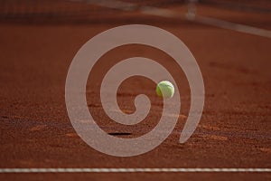 Clay tennis court and tennis ball