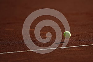 Clay tennis court and tennis ball