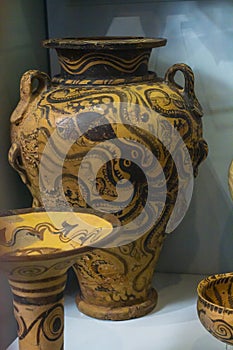 Clay vessel for offering, storing and costuming liquids, decorated with Marine and Floral Style motifs, double axes and spirals.