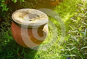 Clay water pot in the garden.