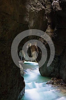 Clean, beautiful, mountain river flows through a rocky grot Partnachklamm in Germany incised by a mountain stream