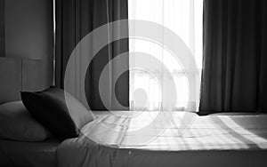 Clean bed with sunlight through from window. Light and shadow on