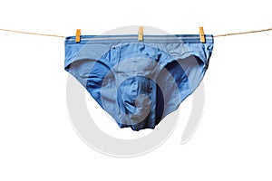 Clean blue man\'s briefs hanging on rope isolated on white background. Clothesline with washed underwear. Hygiene concept