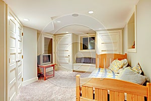 Clean and bright basement bedroom with white walls and carpet.