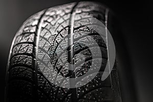 Clean car tyres spinning against dark background