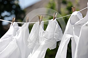 Clean clothes hanging on washing line in garden. Drying laundry