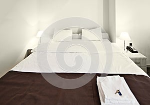 Clean, comfortable bed in modern hotel room.