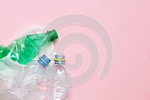 Clean crumpled plastic water bottles and white plastic bag ready for recycling