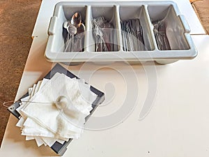 clean cutlery in a cutlery box with knives, forks, spoons in a canteen.