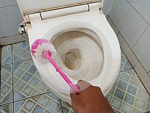 clean the dirty toilet wc with a brush to keep it clean