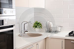 Clean dishes on counter near kitchen sink