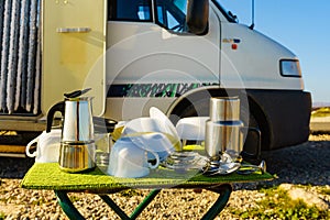 Clean dishes drying on fresh air, capming outdoor photo
