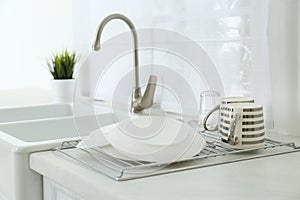 Clean dishes drying on rack in kitchen