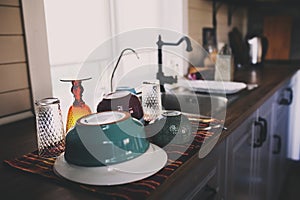 clean dishes in modern kitchen. Washing plates, glasses and tableware