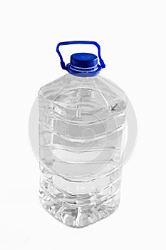 Clean drinking water in a plastic bottle on a white background. 5 liters.