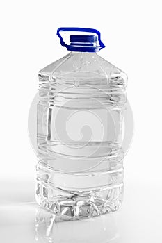 Clean drinking water in a plastic bottle on a white background. 5 liters.