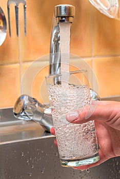 Clean drinking water is poured from the kitchen tap