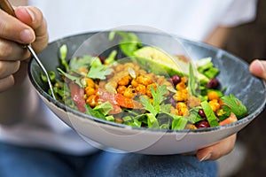 Clean eating, vegan healthy salad bowl closeup , woman holding salad bowl, plant based healthy diet with greens, salad, chickpeas