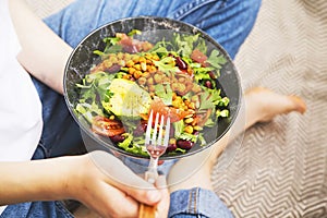 Clean eating, vegan healthy salad bowl , top view of woman holding salad bowl, plant based healthy diet with greens, salad,