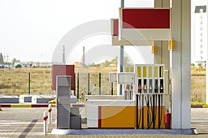 Clean empty auto gas station exterior on sunny day on rural landscape and bright sky copy space background