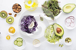 Clean food. Fresh raw vegetables and lettuce leaves to prepare a healthy snack meal salad. Top view. On a light