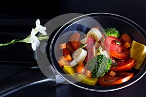 Clean food, mix fruit and herb in pan on dark background