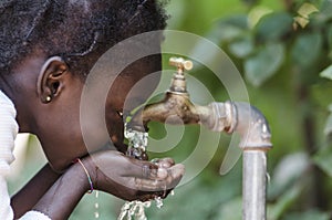 Clean Fresh Water Scarcity Symbol: Black Girl Drinking from Tap.