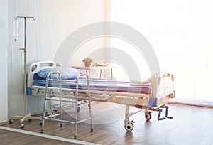 Clean and hospitality of room with empty bed and medical equipment in hospital