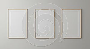 Three Vertical Blank Wooden Frames Mockup on Gray Wall