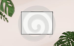 Clean and minimalist front view horizontal black photo or poster frame mockup hanging on the wall with blurry plant. 3d rendering