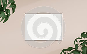 Clean and minimalist front view horizontal black photo or poster frame mockup hanging on the wall with blurry plant. 3d rendering