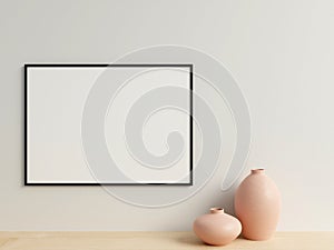 Clean and minimalist front view horizontal black photo or poster frame mockup hanging on the wall with vase. 3d rendering