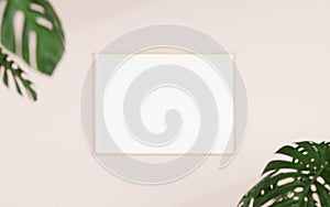 Clean and minimalist front view horizontal wooden photo or poster frame mockup hanging on the wall with blurry plant. 3d rendering