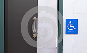 Clean and modern bathroom for disabled people with the sign of person in a wheelchair in blue. Concept of handicapped people