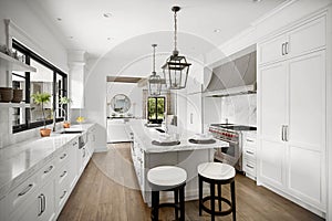 a clean modern kitchen with stainless steel appliances, white countertops, and wooden floors