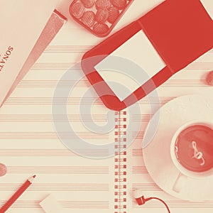 Clean music sheet, closed notes, pencil, metal box of sugar candies, glasses, case with two mockup business cards, head