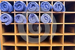 Clean nice shape of blue rolled towel in wooden box