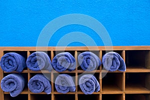 Clean nice shape of blue rolled towel in wooden box