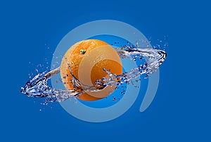 Clean orange with splashes of water isolated on blue background