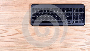 Clean and organized red oak desktop with modern wireless keyboard