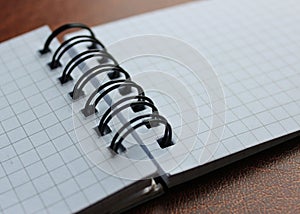 Clean Pages Of Spiral Checkered Notebook On Expensive Leather Macro Shot Photo