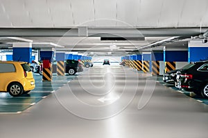 Clean parking garage with cars and lights