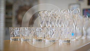 Clean plates, glasses and cutlery on wooden table. Catering set-up ready for the event to begin. ervice area the waiter in