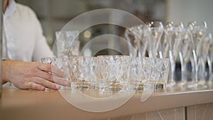 Clean plates, glasses and cutlery on wooden table. Catering set-up ready for the event to begin. ervice area the waiter in