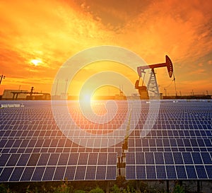 Clean power energy concept,Oil pump with solar panels and the sunset