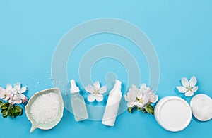 Clean pure spring beauty products background. White objects moisturizing creams, pipette oil bottle, bath salt in bowl.