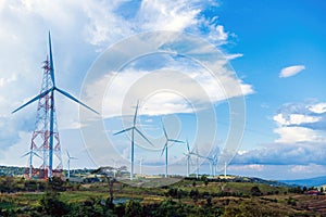 Clean and renewable energy to reduce carbon emissions concept, many wind turbines generating electricity, bright blue sky